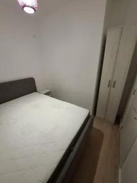 Furnished bedroom with a double bed and a wardrobe. - image 10