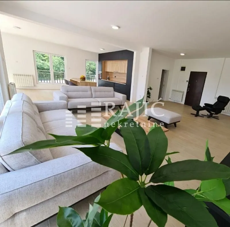 Spacious bright living room connected to the dining area and kitchen.
