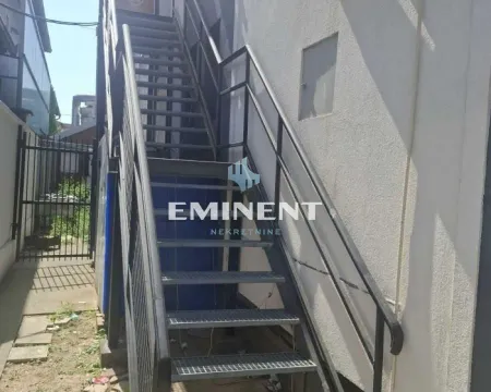 External metal stairs with a railing at the building entrance. - image 17