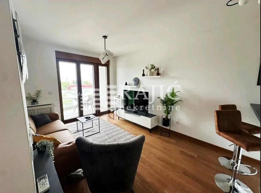Living room with sofa, TV, and bar stools.