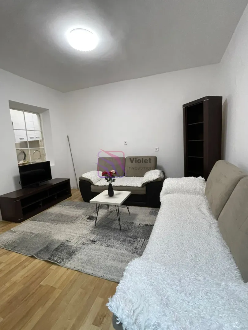 Living room with a sofa set, coffee table, and TV.