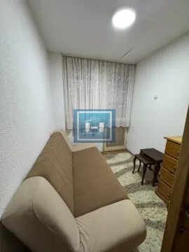 Small living room with a pull-out sofa and a window with curtains. - image 5