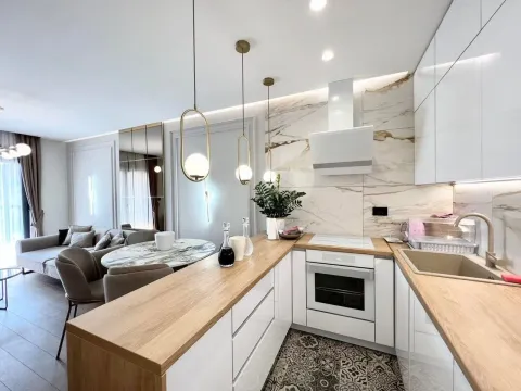 Modern kitchen with wooden countertops and a dining area. - image 7