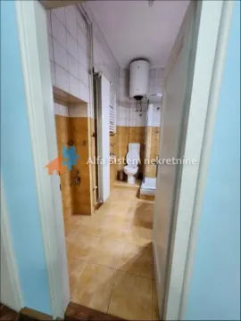 View of the bathroom with ceramic tiles, toilet, and shower cabin. - image 12