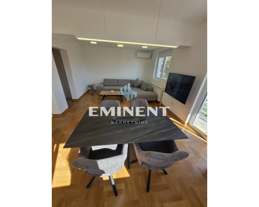 Living room with a dining table and sofa set.