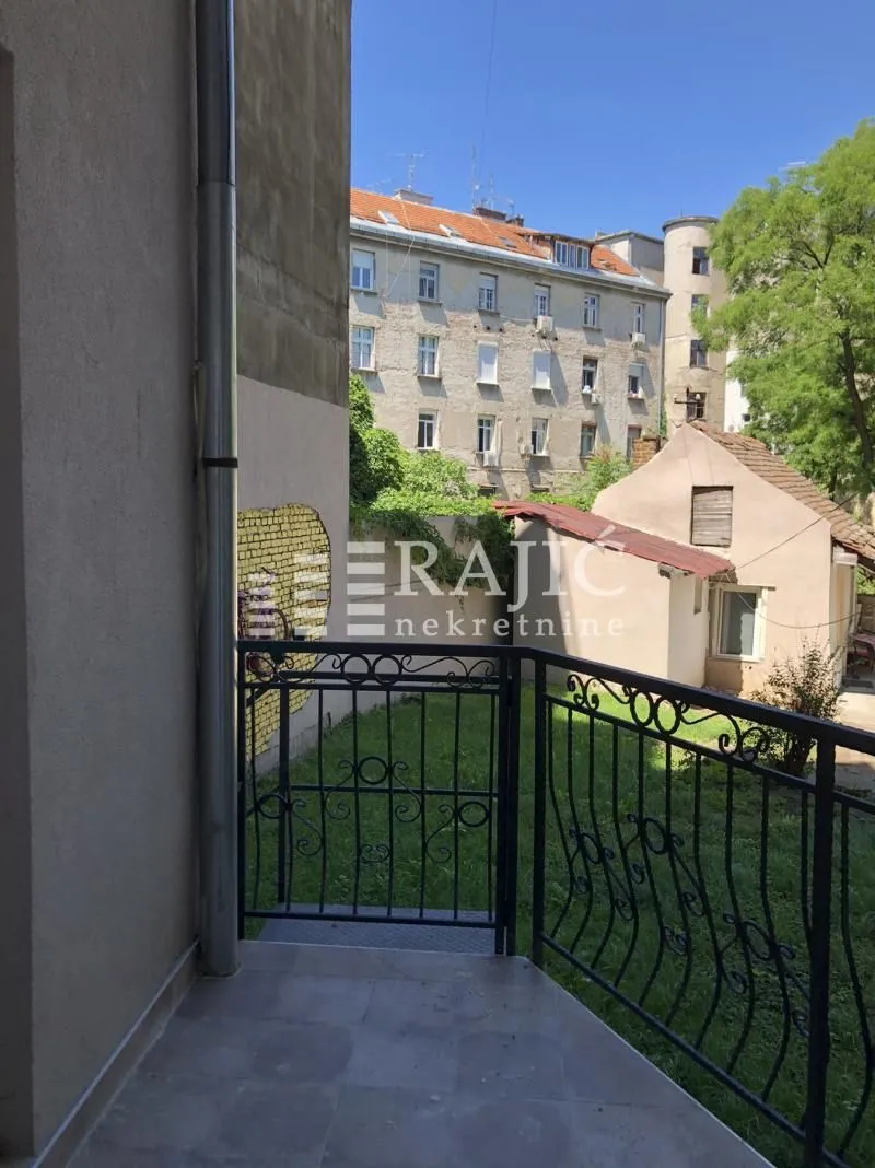 View from the terrace overlooking the courtyard and surrounding buildings.