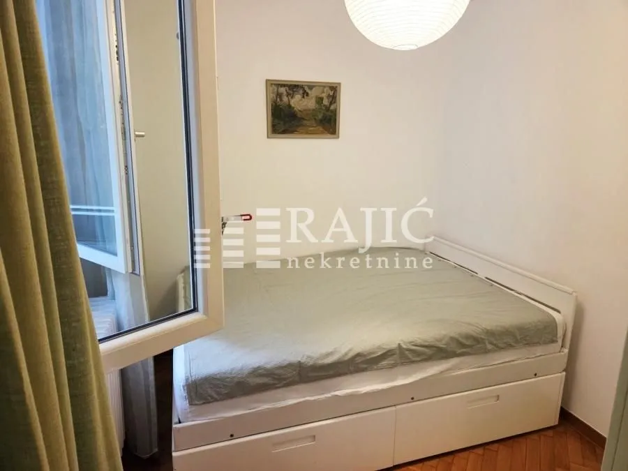 Small bedroom with a double bed and a window.