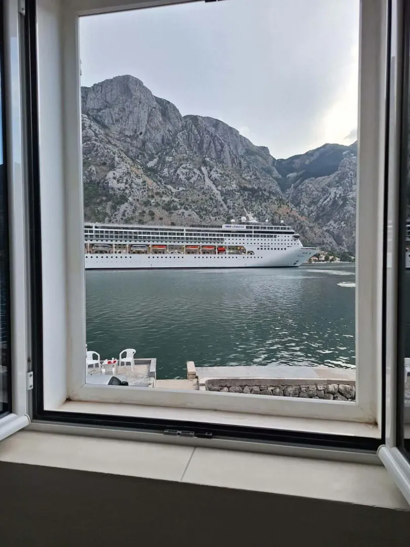 View of the bay and cruise ship through a window.