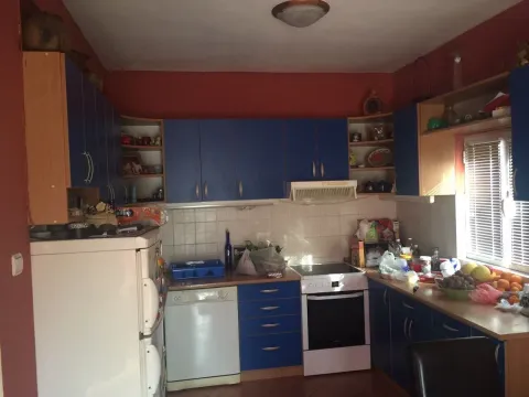 Kitchen with blue cabinets and appliances. - image 14