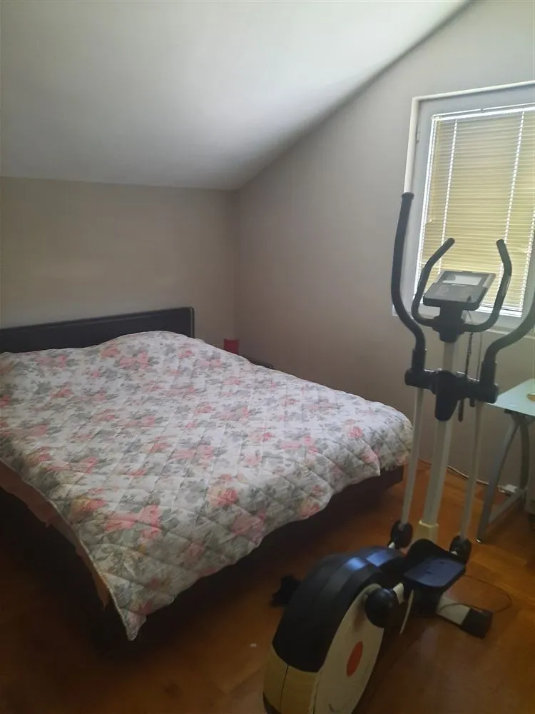 Bedroom with a double bed and an elliptical trainer.