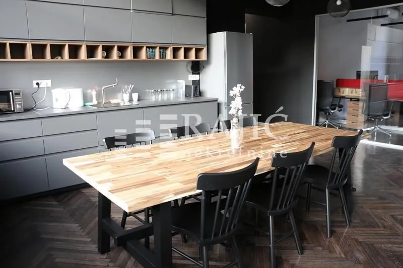 Kitchen with a dining table and grey cabinets.