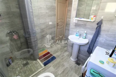 Bathroom with a shower cabin, washbasin, and tiled walls. - image 2