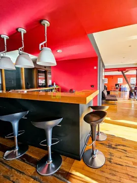 Modern kitchen with a bar counter and bar stools. - image 11