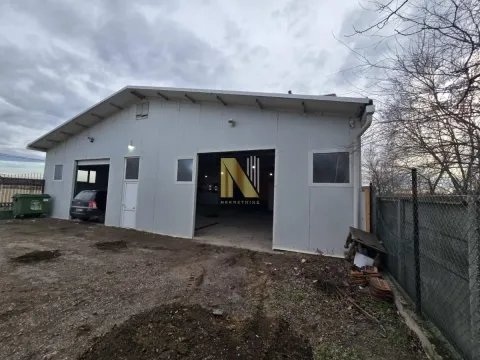 Exterior of a commercial building or warehouse with a yard. - image 9
