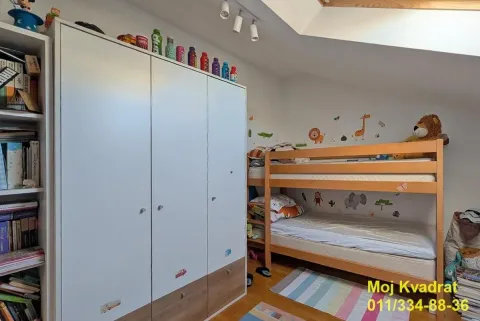 Children's room with a bunk bed and a white wardrobe. - image 8