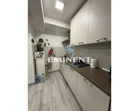 Compact kitchen with light-colored cabinets and built-in appliances. - image 6