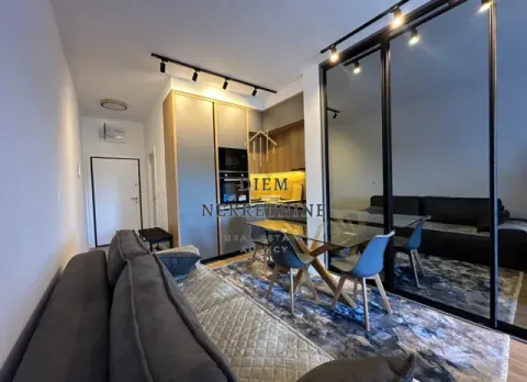 Modern living room with dining area and kitchen in the background. - image 2