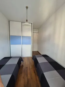 Small bedroom with two single beds and a built-in wardrobe. - image 8