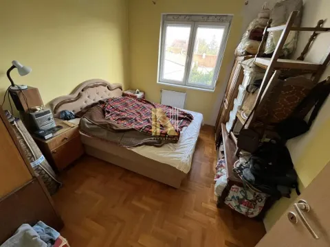 Manja spavaća soba sa krevetom i drvenim ormarima. - image 3