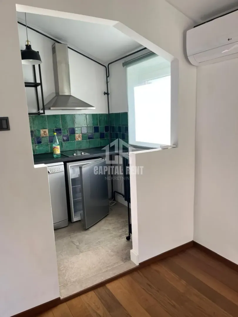 Smaller kitchen with an open pass-through and built-in appliances.