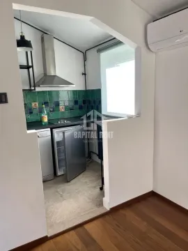 Smaller kitchen with an open pass-through and built-in appliances. - image 16
