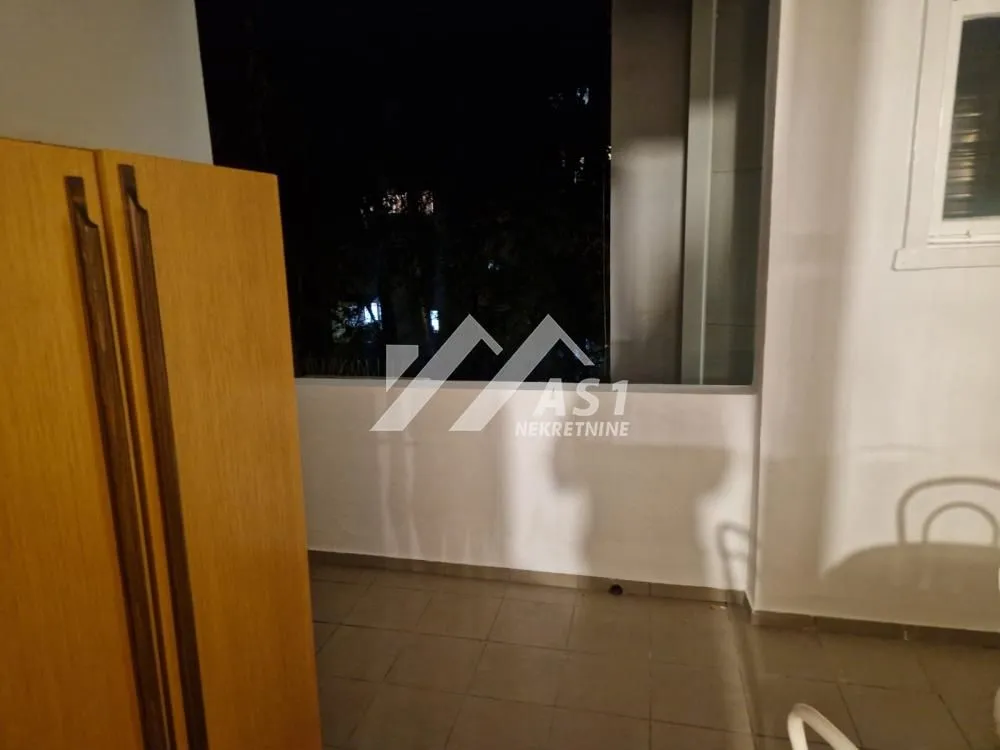 A view of the uncovered part of the terrace with furniture at night.