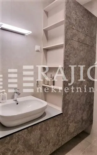 Modern bathroom with a sink and built-in cabinet.