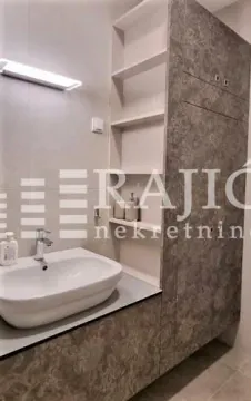 Modern bathroom with a sink and built-in cabinet. - image 10