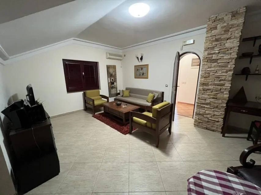 Living room with a seating set and a decorative stone wall.