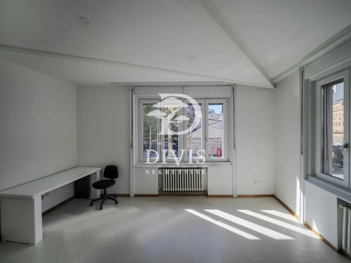 Empty bright room with white walls and an office desk.