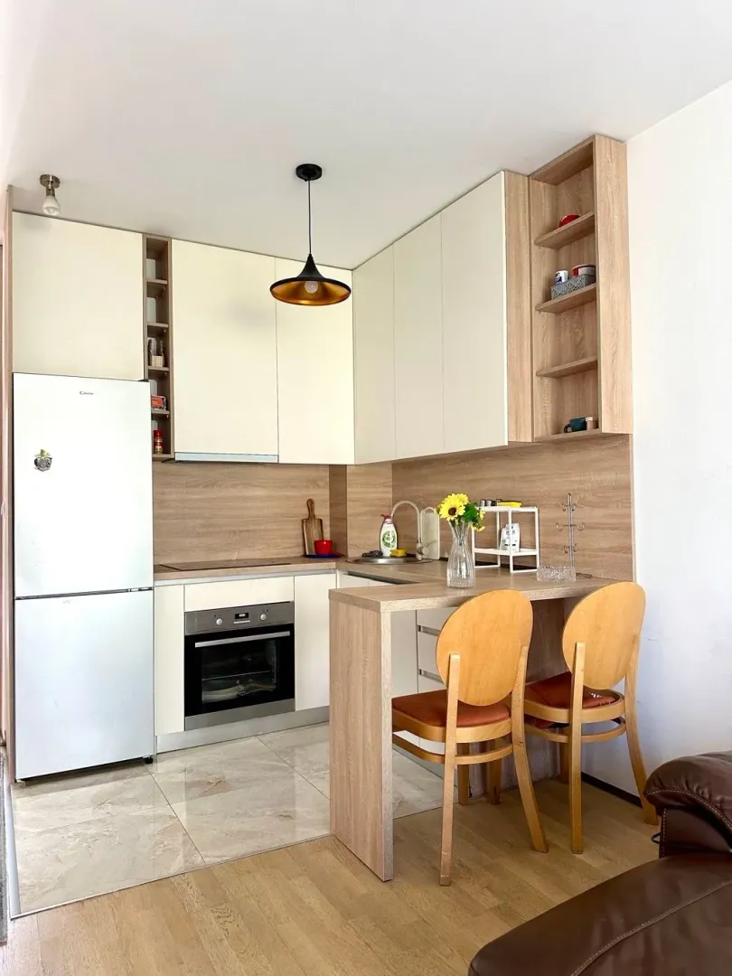 Small kitchen with a dining area and built-in appliances.