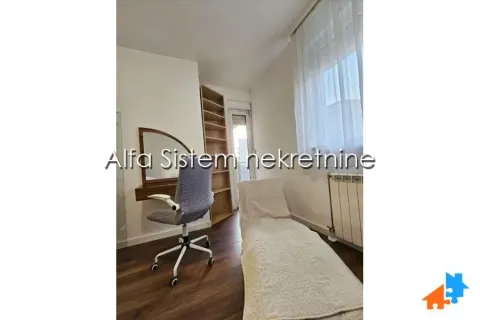 Smaller bedroom with a bed, desk, and access to the terrace. - image 14