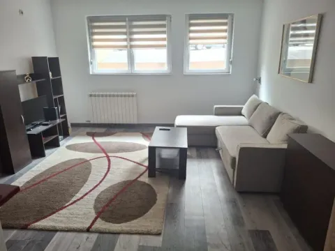 Living room with a sofa, coffee table and TV unit. - image 3