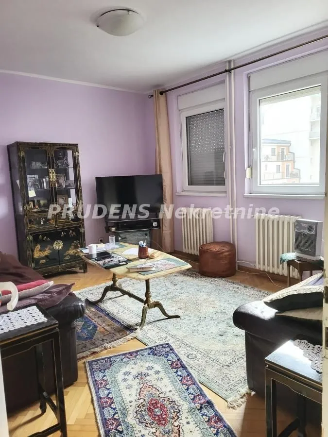Living room with a sofa set, television, and coffee table.