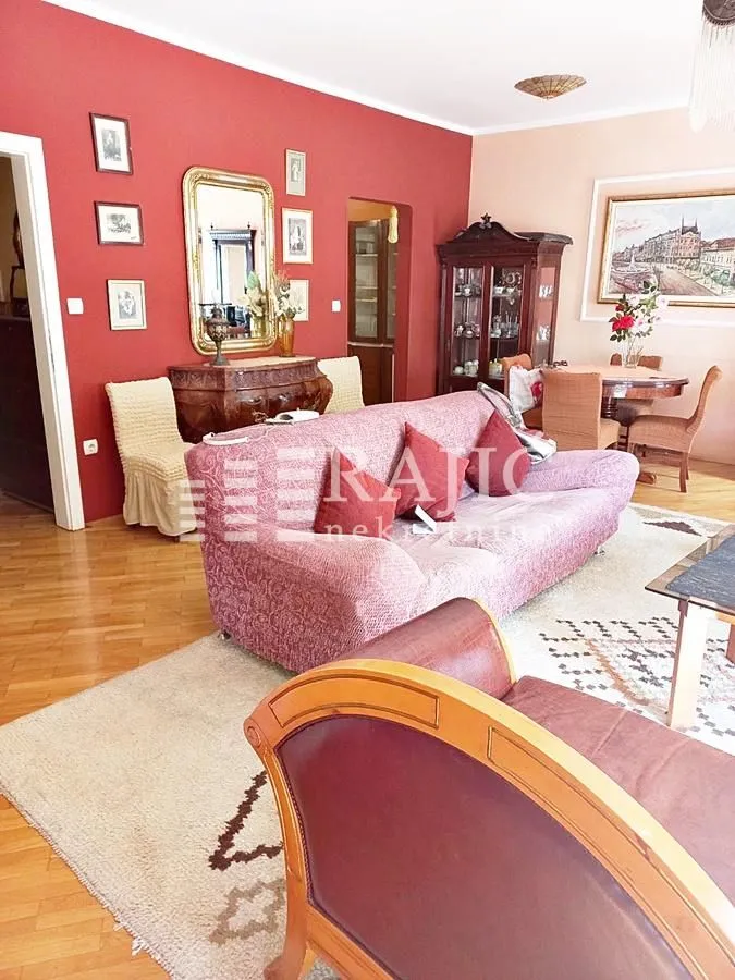Spacious living room with a sofa set and a dining area in the background.