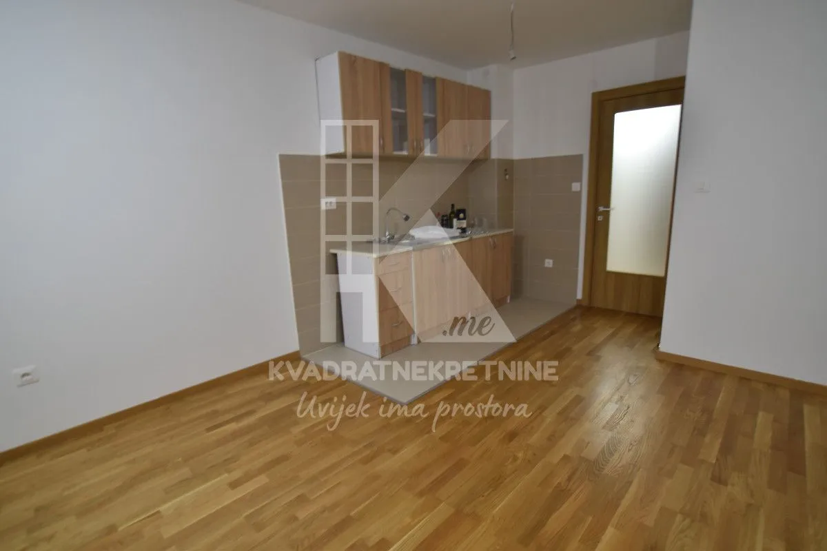 Small kitchen with wooden elements within the apartment.