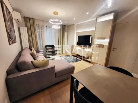 Modern and bright living room with a sofa and dining table. - image 2