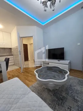 Living room with sofa, TV and view of the kitchen. - image 3
