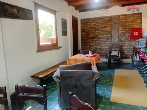 Living room with seating furniture and a brick wall. - image 8