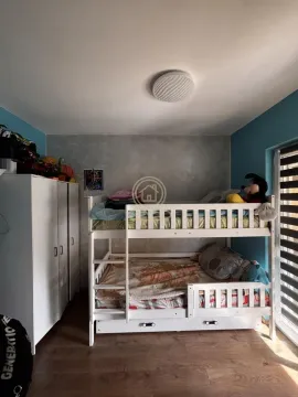 Children's bedroom with a bunk bed and a white wardrobe. - image 9