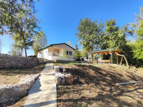View of the house with a landscaped yard, pathway, and canopy in nature. - image 9