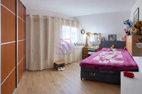 Furnished bedroom with a double bed, large wardrobe, and a window. - image 7