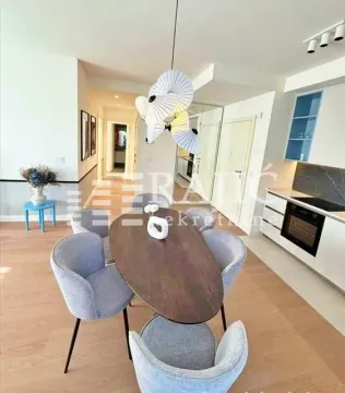 Dining area connected to the kitchen in a modern apartment. - image 4
