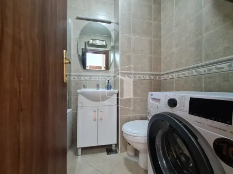 Smaller bathroom with a sink, toilet, and washing machine. - image 10