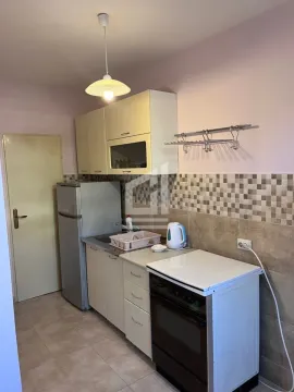 Smaller kitchen with cabinets, refrigerator and stove. - image 6