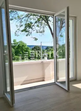 View from a bright room towards the terrace and greenery. - image 2
