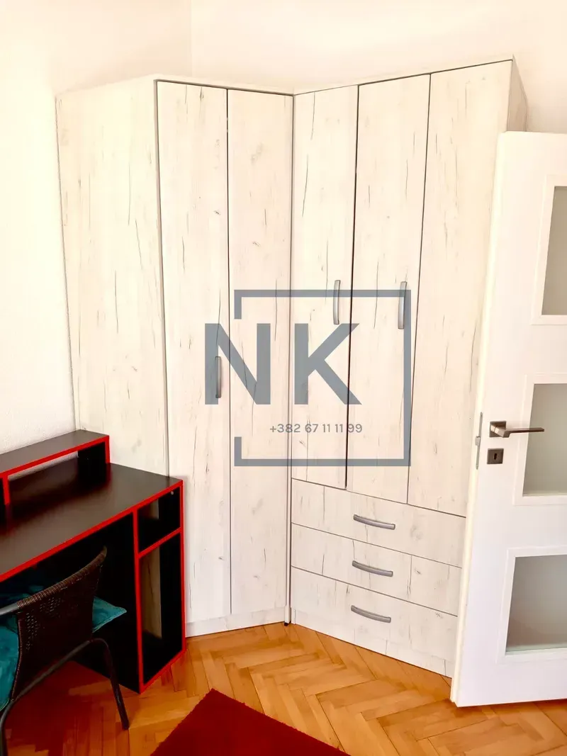 Bedroom with a large built-in wardrobe and a desk.