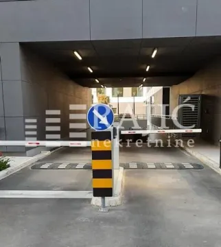 Entrance to the building's underground garage with a ramp and traffic sign. - image 15