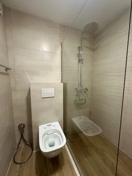 Modernly equipped bathroom with a walk-in shower and toilet. - image 11