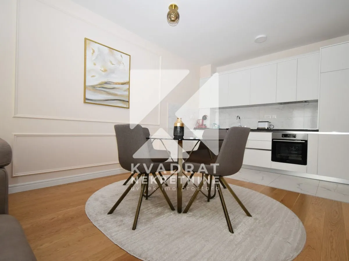 Modern kitchen with a dining area and built-in appliances.